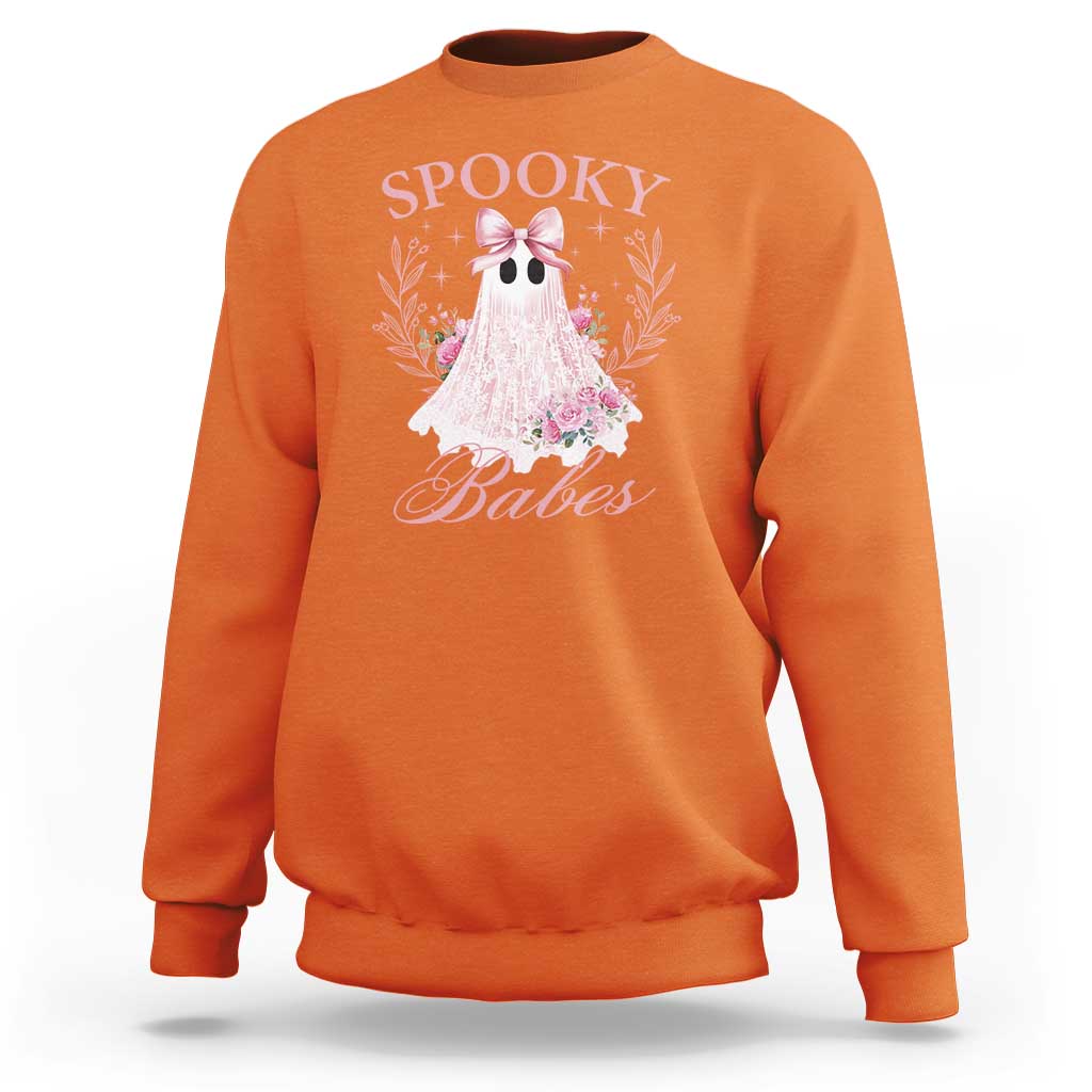 Orange Halloween sweatshirt with pink ghost graphic, bow, and floral accents on front.