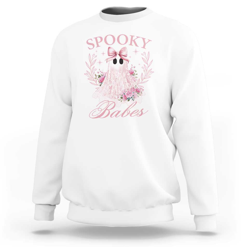 White Halloween sweatshirt with pink ghost graphic, bow, and floral accents on front.