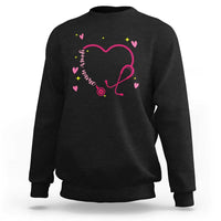 Black crewneck sweatshirt with pink heart stethoscope graphic and small colorful hearts