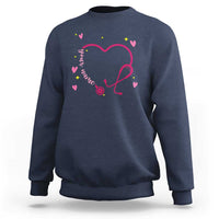 Navy crewneck sweatshirt with pink heart stethoscope graphic and colorful heart accents