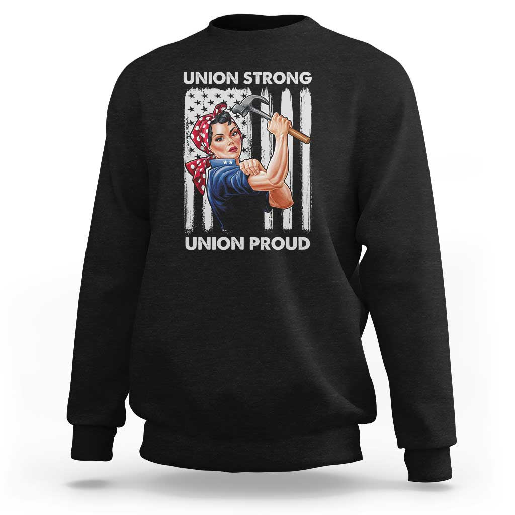 Black sweatshirt with crew neck and front graphic of woman holding a hammer