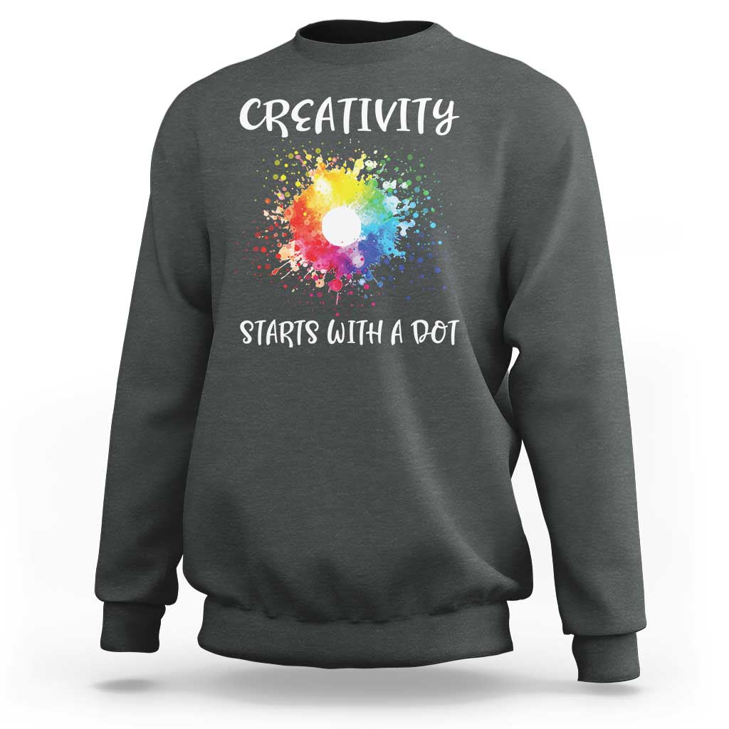 Charcoal heather crewneck sweatshirt with colorful dot graphic and “CREATIVITY STARTS WITH A DOT”
