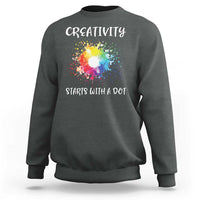 Charcoal heather crewneck sweatshirt with colorful dot graphic and “CREATIVITY STARTS WITH A DOT”