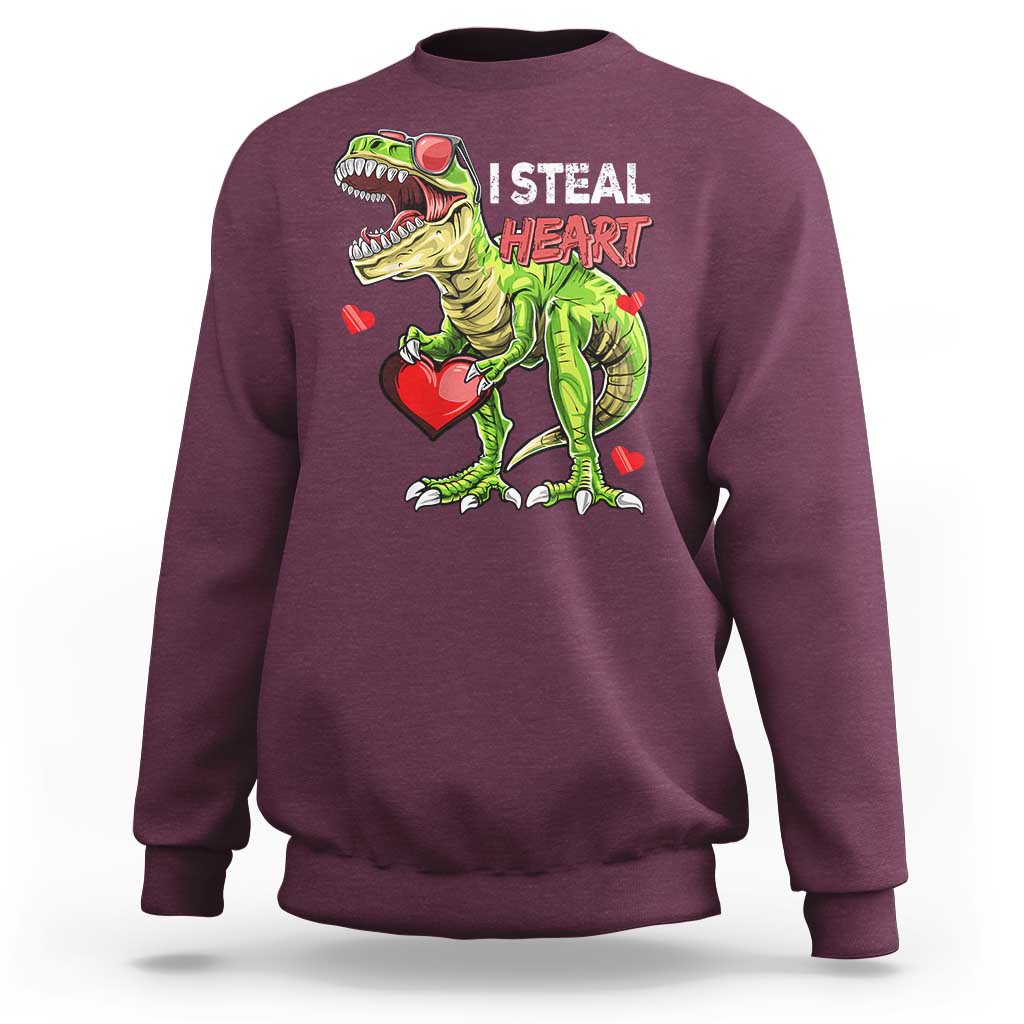 Maroon sweatshirt with cartoon dinosaur holding a red heart and “I STEAL HEARTS” print