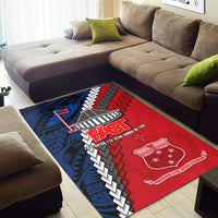 Blue & red area rug on wood floor with FAST text, geometric motifs, and shield emblem