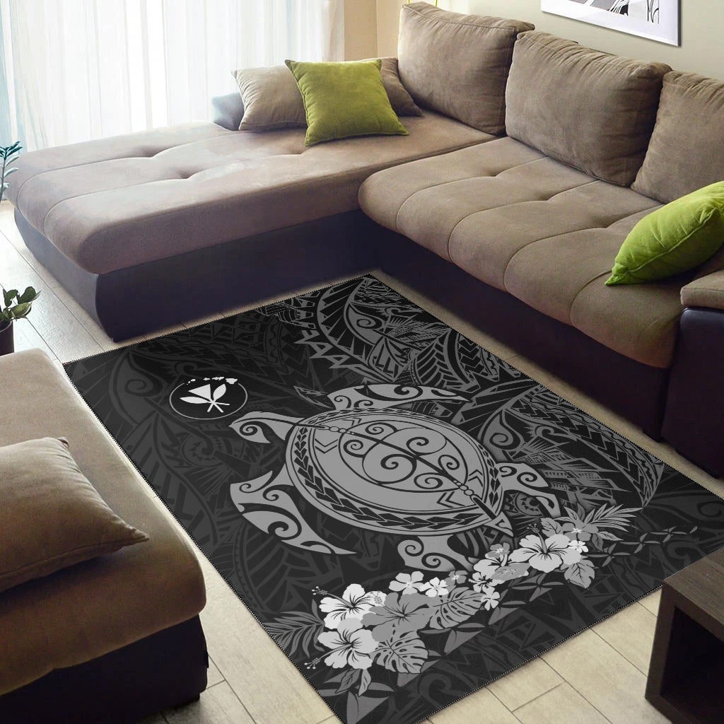 Dark Hawaiian area rug with sea-turtle and floral graphic in tribal-pattern center
