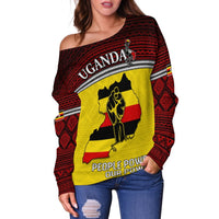 Off-shoulder sweater close-up: Uganda text and People Power graphic on red and yellow