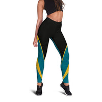 Black-to-teal active leggings with bold yellow geometric side panels and tapered legs