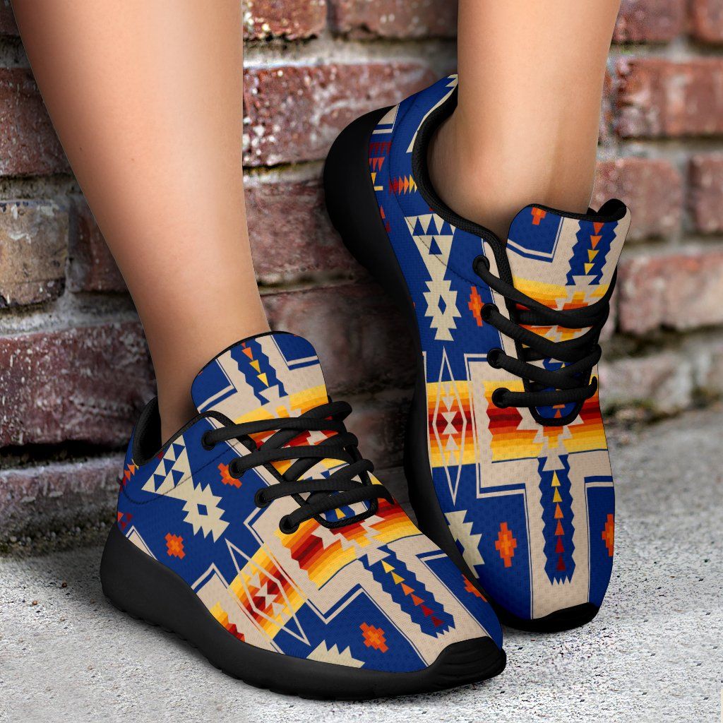 Blue lace-up sport sneakers with multicolor geometric print and black outsole, worn