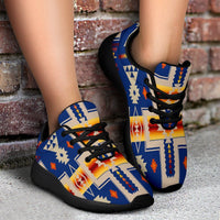 Blue lace-up sport sneakers with multicolor geometric print and black outsole, worn