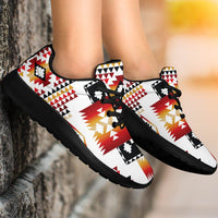 Multicolor Native-style sport sneakers on feet, black laces and thick black sole