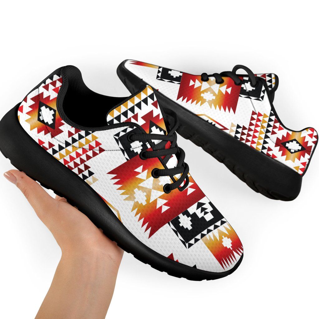 Native-style print sport sneakers with black laces and soles, angled pair view