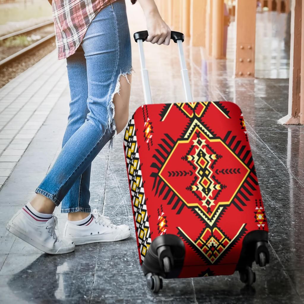 Red suitcase cover with Native geometric pattern, pulled over rolling luggage
