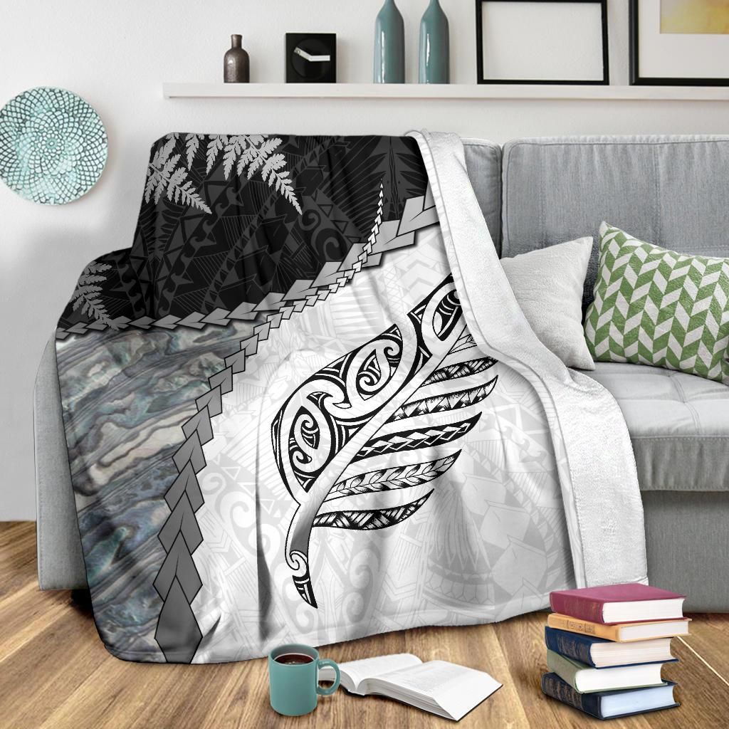 White premium blanket with black fern and stylized feather crest, gray stone-like pattern panel left