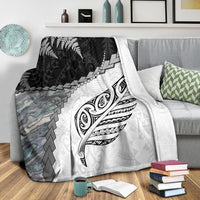 White premium blanket with black fern and stylized feather crest, gray stone-like pattern panel left