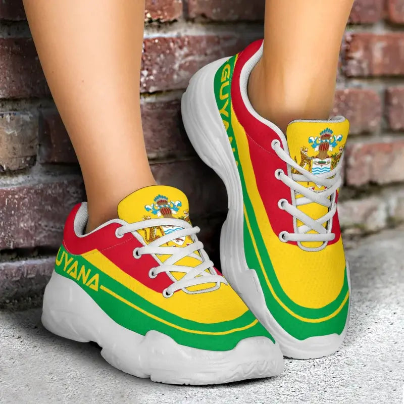 Chunky sneakers with Guyana flag colors; red/yellow/green panels, white laces, white sole