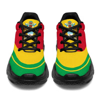 Pair of Guyana flag chunky sneakers, front view; black sole, red upper, green and yellow bands