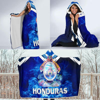 Honduras hooded blanket worn and held, blue smoke print with white zigzag trim