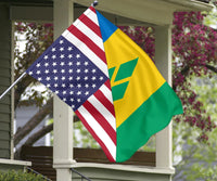 Flag hanging from porch columns with US stars and stripes and Saint Vincent green-yellow-blue