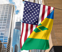 Tall flag flying from building mast with US stars, stripes, and Saint Vincent green-yellow-blue