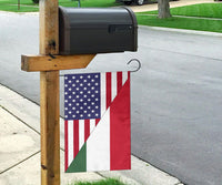 US and Hungary flag on a wooden post, with blue star field, red-white stripes, green triangle