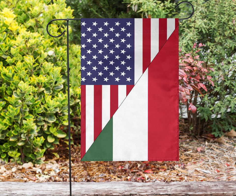 US and Hungary garden flag on a stake in landscaping, blue stars, red stripes, green-white-red triangle