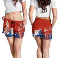Red smudge-print drawstring shorts on model, blue-and-white graphic front panels