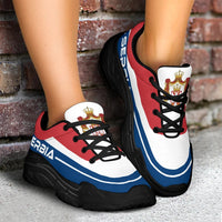 Chunky lace-up sneakers pair, red/white/blue with black soles and crown badge