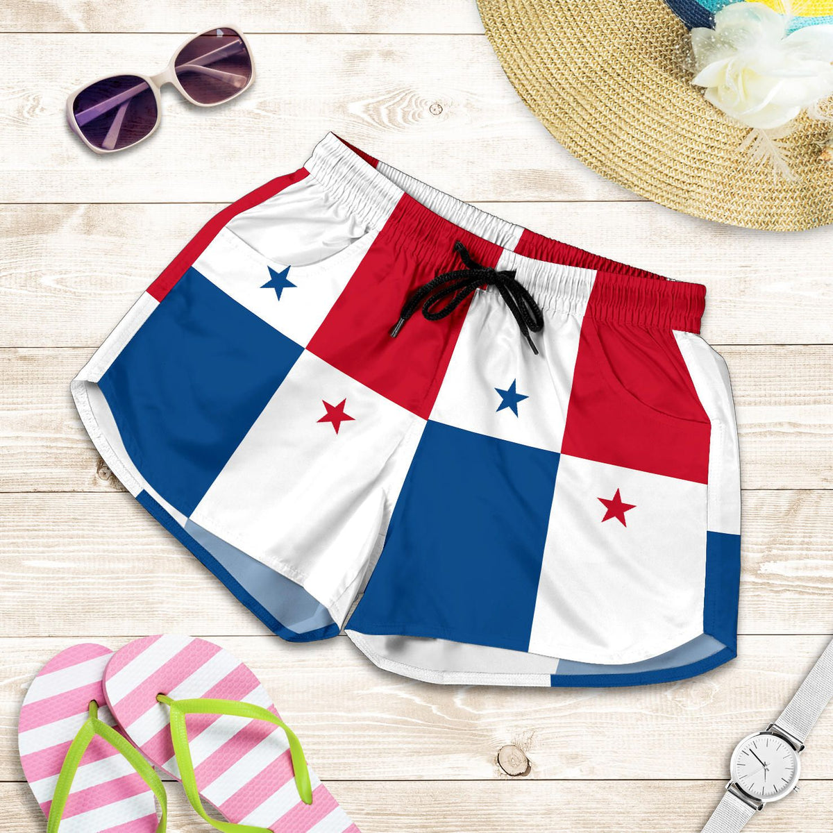 Flag-print women’s shorts flat lay, elastic waistband and black drawstring; red white blue blocks