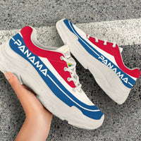 Chunky sneakers on white box, red and white uppers with blue stripe, thick white platform sole