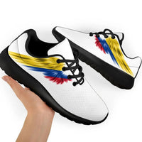 Two white sneakers with Colombia flag wings graphic and black outsole