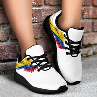 White sneakers with Colombia flag wings print and black sole, side view