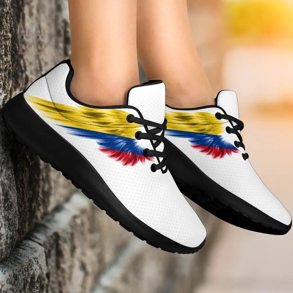White sneakers with Colombia flag wings design, black laces and dark outsole