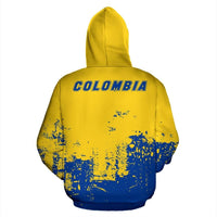 Pullover hoodie amarilla con parte inferior azul y texto COLOMBIA en la espalda