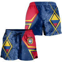 Colombia shorts close-up, blue fabric with red panel, geometric symbols, elastic waistband