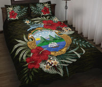 Black quilt bed set with Costa Rica crest, red hibiscus and tropical leaf print