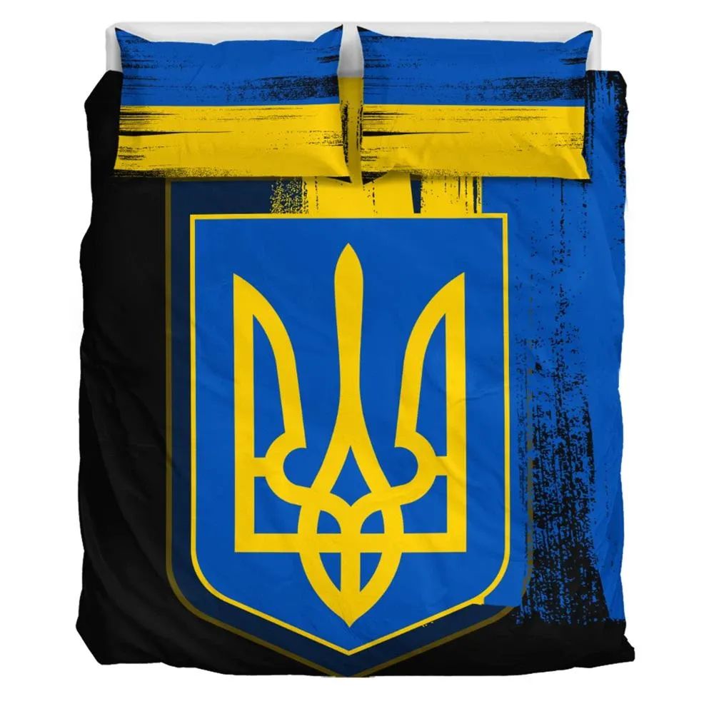 Close-up of Ukrainian trident bedding set: bold blue and yellow emblem on dark backing