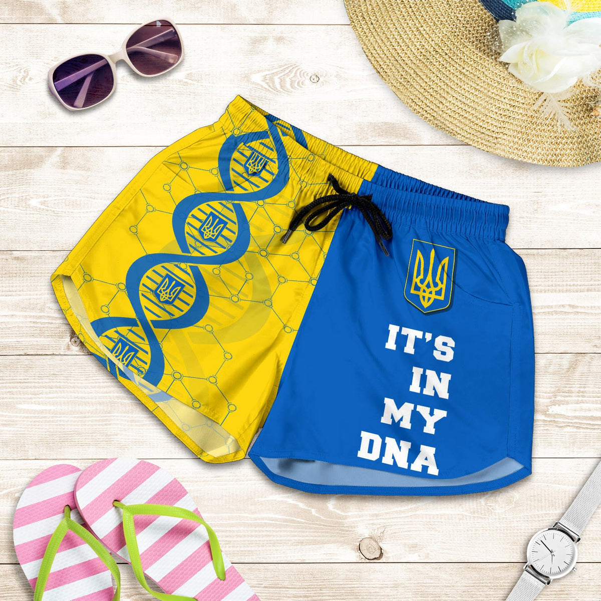 Flat-lay pair of blue and yellow DNA print shorts with drawstring and elastic waist