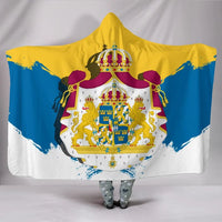 Hooded blanket with yellow-blue-white Swedish crest graphic and bold maroon shoulder tassels