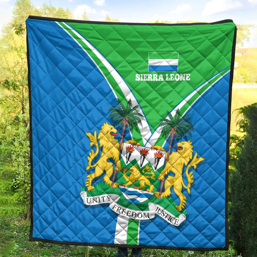 Sierra Leone pride quilt full view outdoors, quilted blue and green with crest center