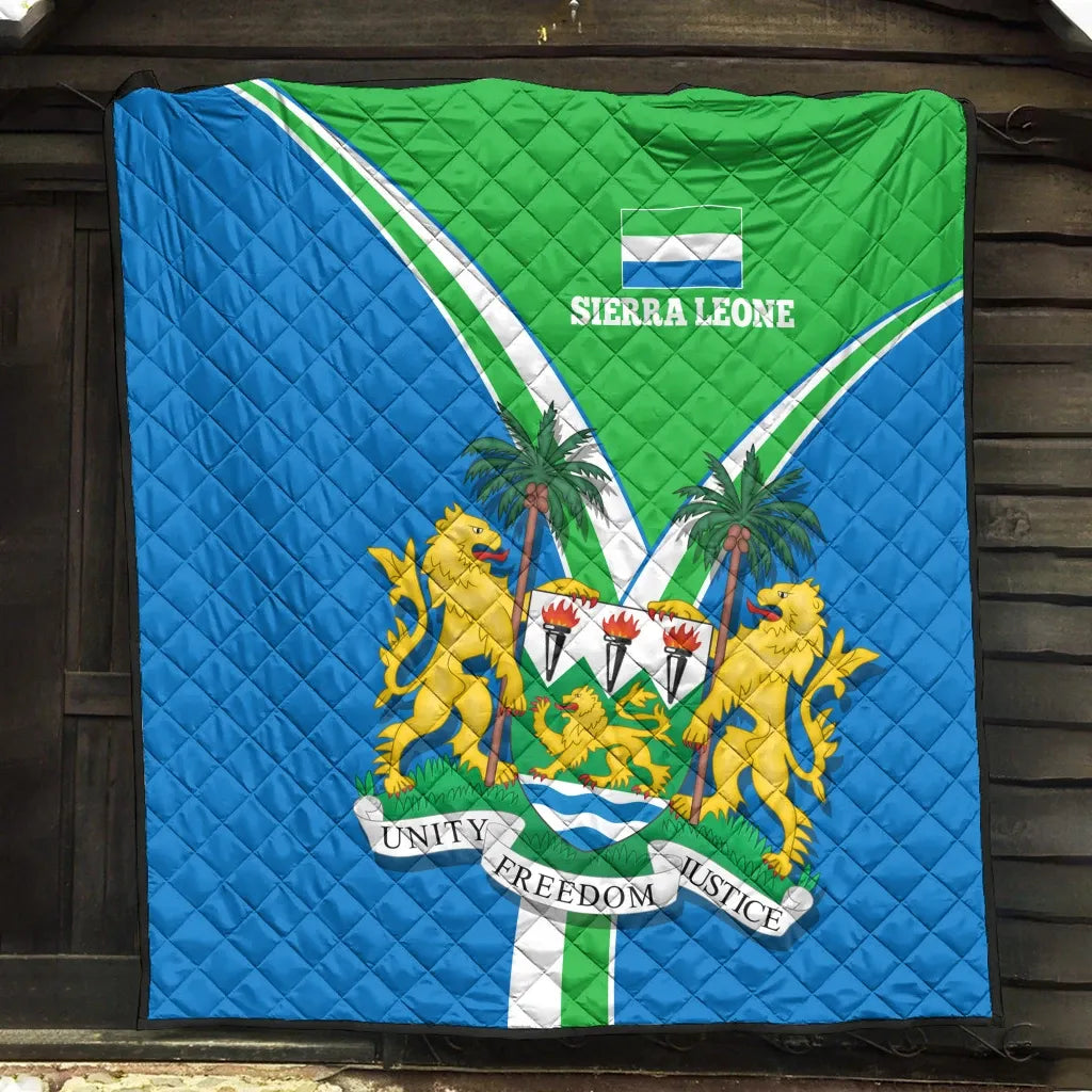 Sierra Leone pride quilt hanging on wall, blue and green flag design with emblem
