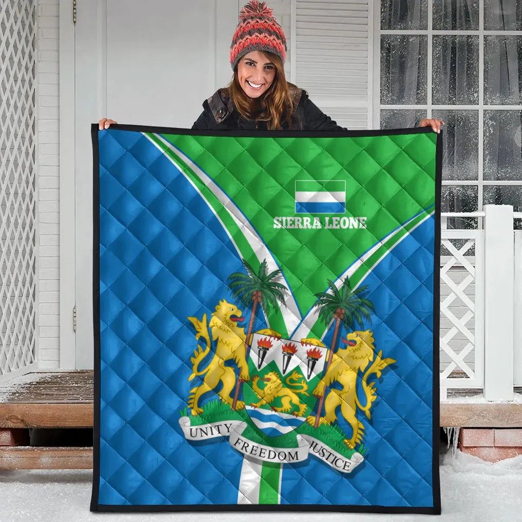 Sierra Leone pride quilt displayed indoors with blue and green flag colors and emblem