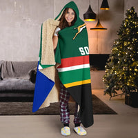 Green hooded blanket with rugby ball emblem, South Africa stripes, beige sherpa trim, worn.