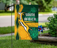 South Africa flag with springbok leaping and “SOUTH AFRICA” headline, green and gold