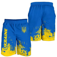 Men’s blue shorts with yellow smudge print, elastic waist, and Ukraine trident logo