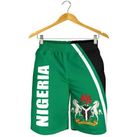 Green Nigeria shorts on hanger with black side panel, white stripe, bold “NIGERIA” text