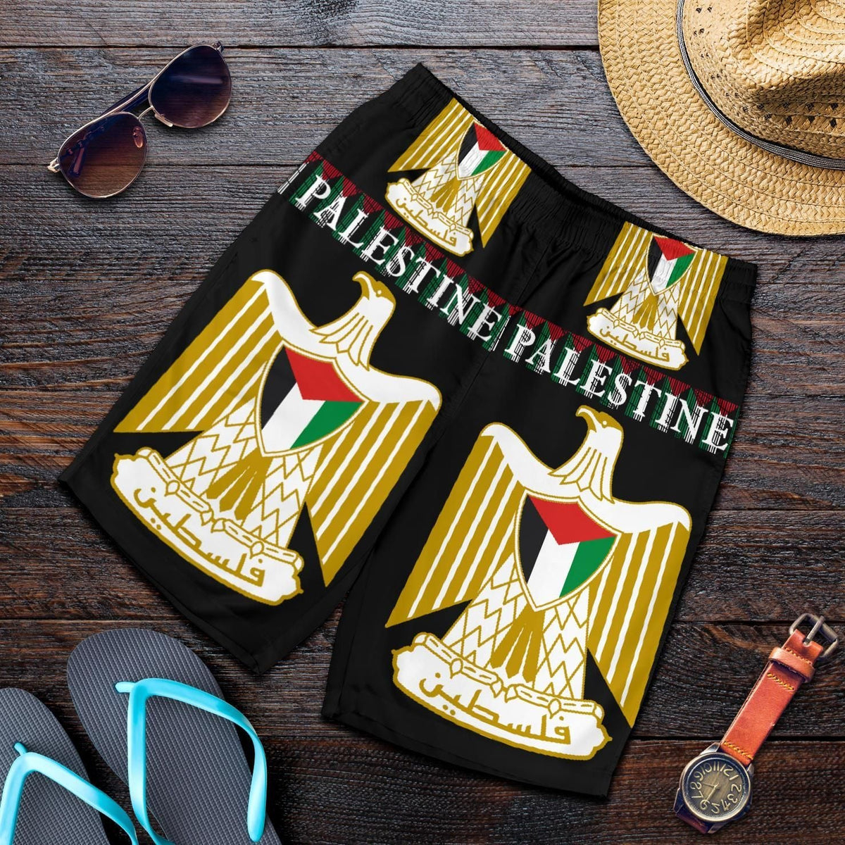 Men's black all-over print shorts with Palestine word and emblem graphic, elastic waistband