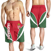 Men's active shorts worn by models: red, green and white flag-style print, elastic waist