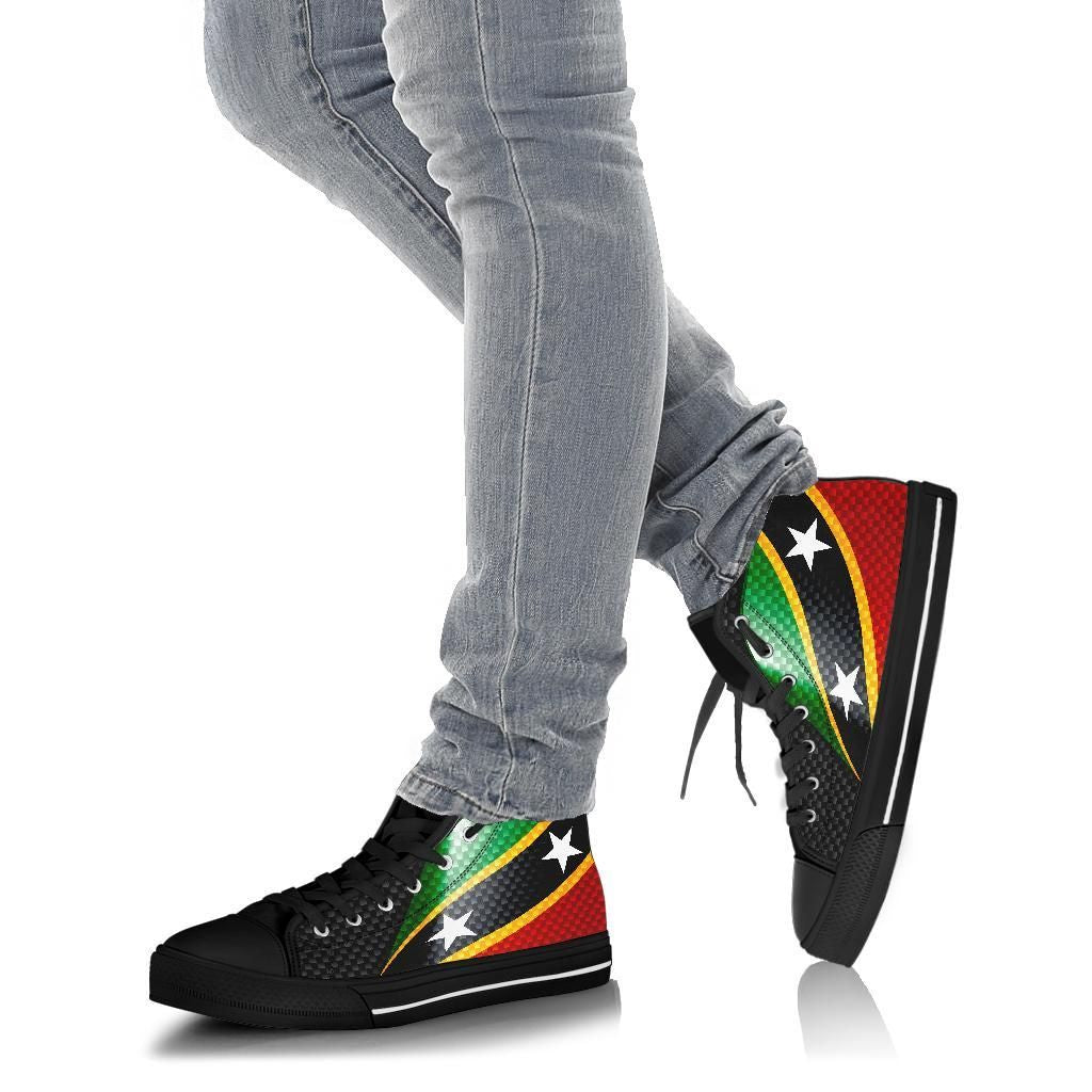 Feet wearing black flag high-top sneakers with laces, paired with blue jeans
