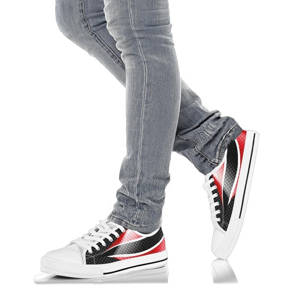 White low top sneakers on jeans, red/white stripe with black checkered trim